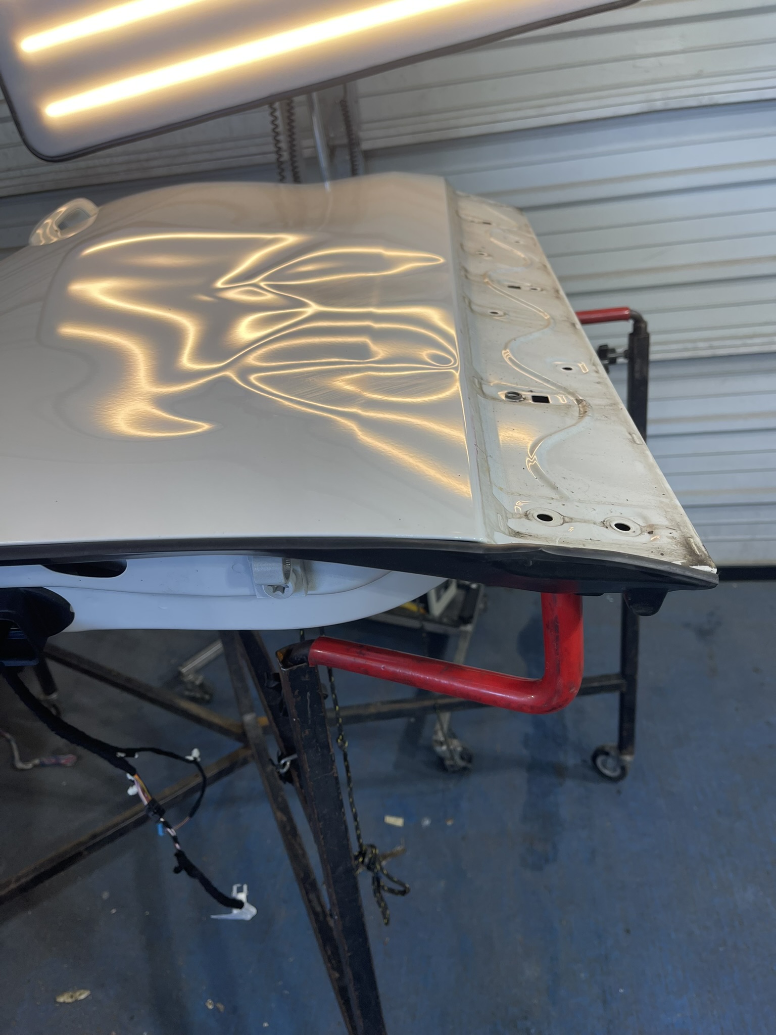 White hood dents before repair